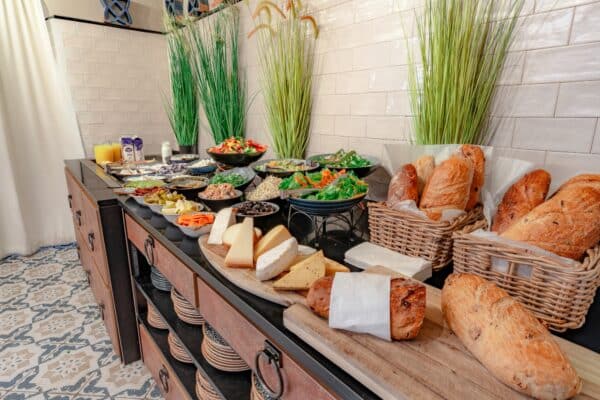Abba Hotel breakfast buffet with salads cheeses fresh breads in baskets and fruit